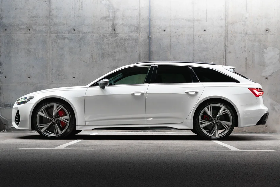 Бял Audi RS6 Avant в профил пред бетонна стена